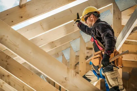 Builder working on the timber framing of a new home