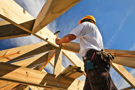 Builder carrying out carpentry repairs on site