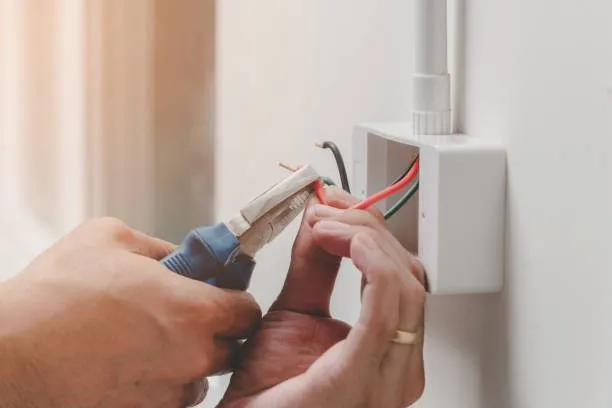 Electrician carrying out wiring work during a build